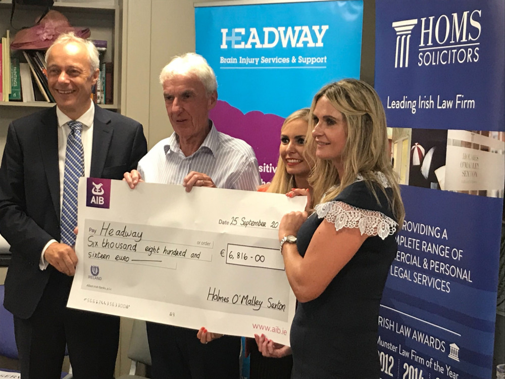 Holmes O'Malley Sexton staff present €6,800 to charity Headway Ireland