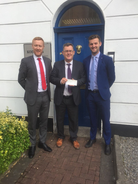 KOD Lyons hand over charity cash from 175km cycle